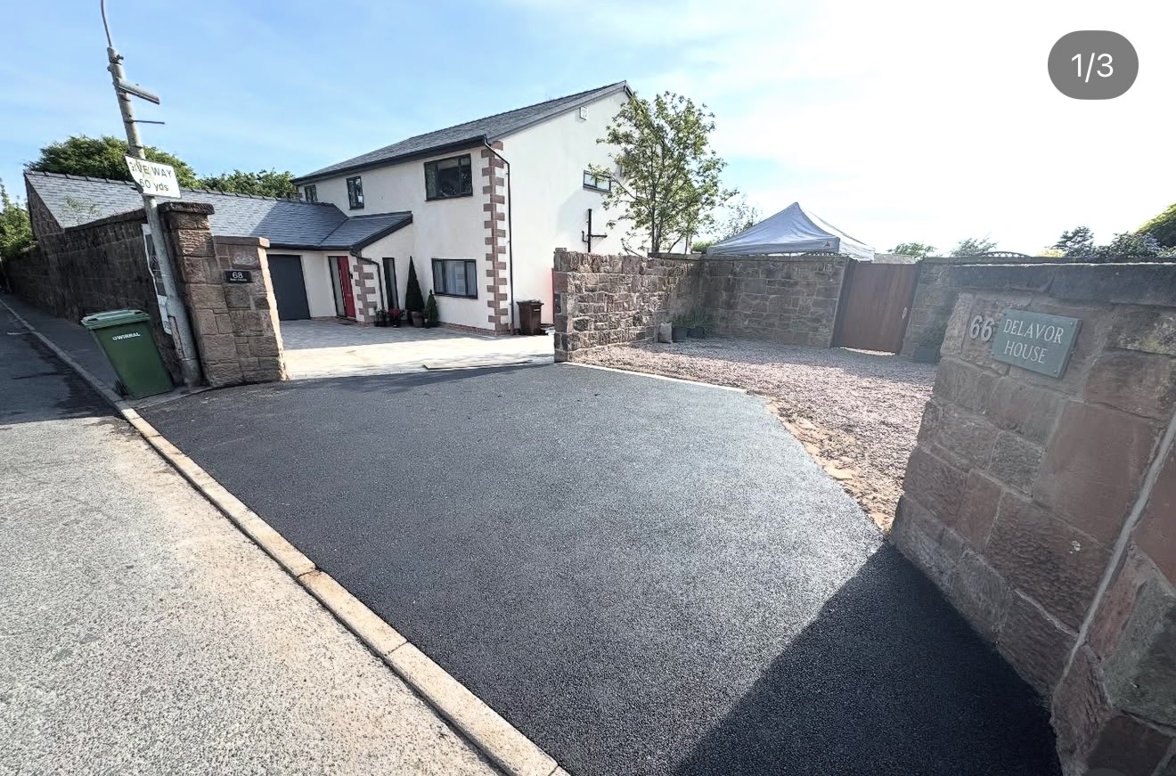 Fresh tarmac driveway with stone walls